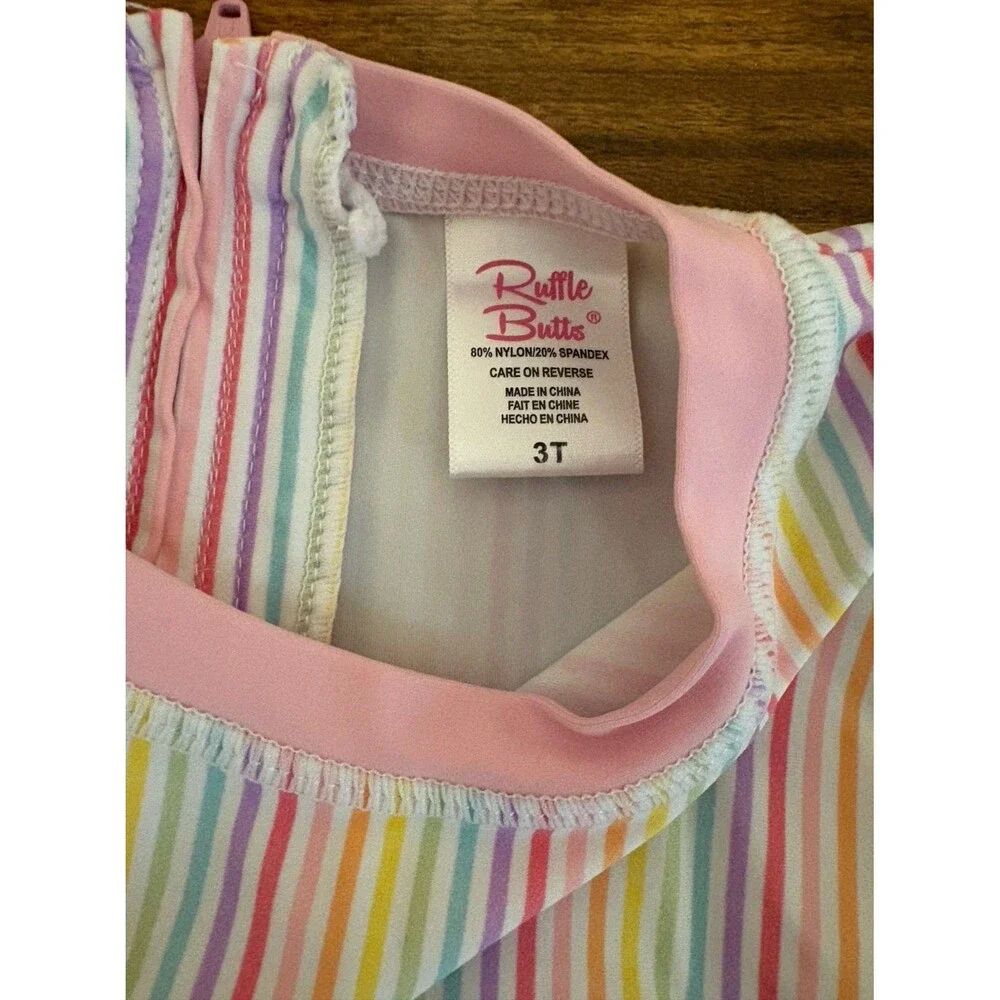 RuffleButts One-Piece Rashguard Swimsuit, Rainbow Stripes, Size 3T